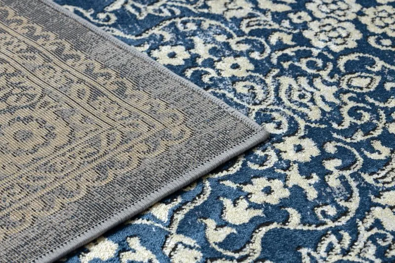Strukturalny dywan DE LUXE 474 w odcieniach granatu i złota - elegancka tekstura