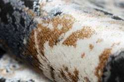 Dywan DE LUXE 629 w szaro-złotej abstrakcji, doskonały do nowoczesnych wnętrz
